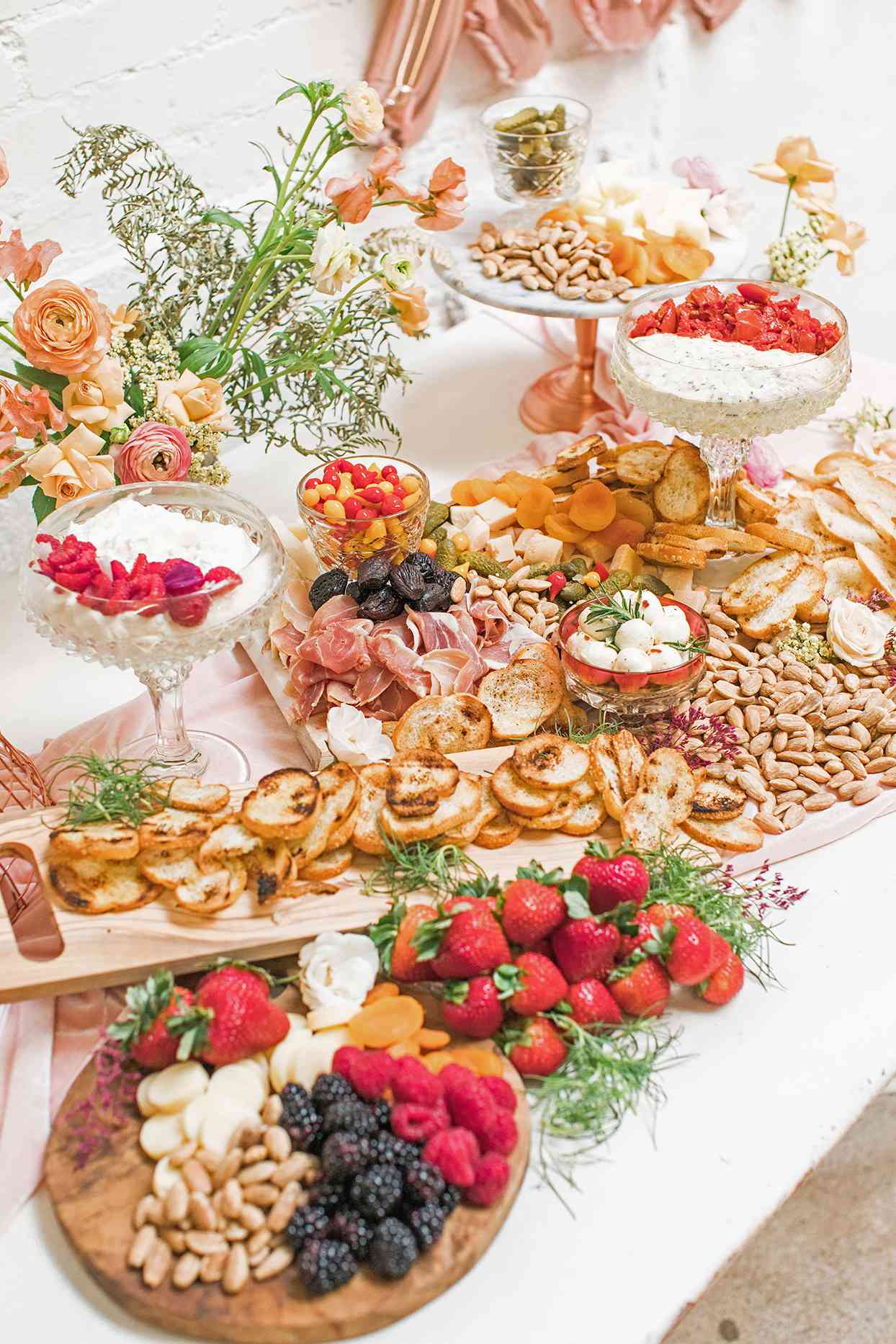 wedding grazing table with pink and peach floral decor