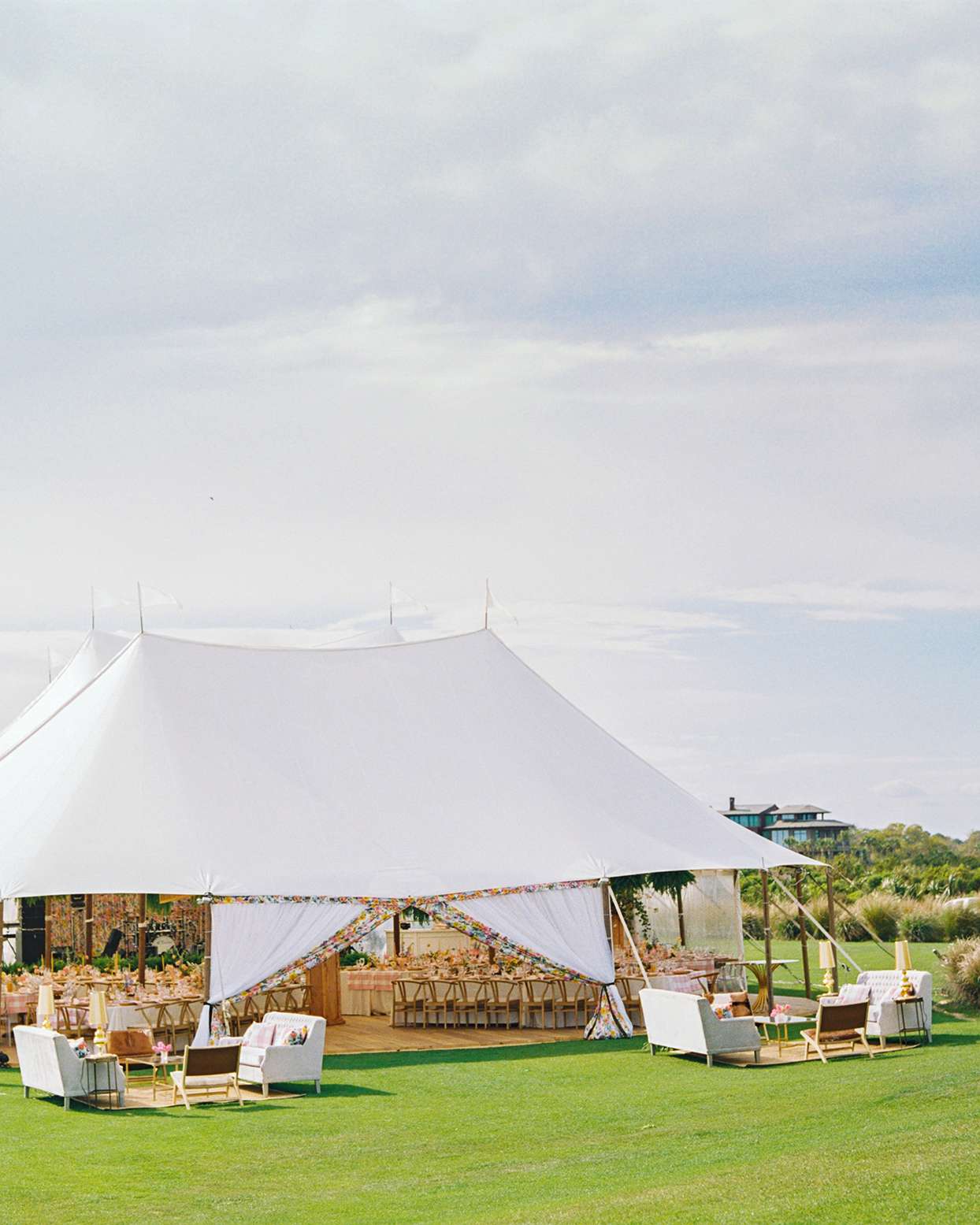lauren dan wedding tent with wooden floor and reception tables