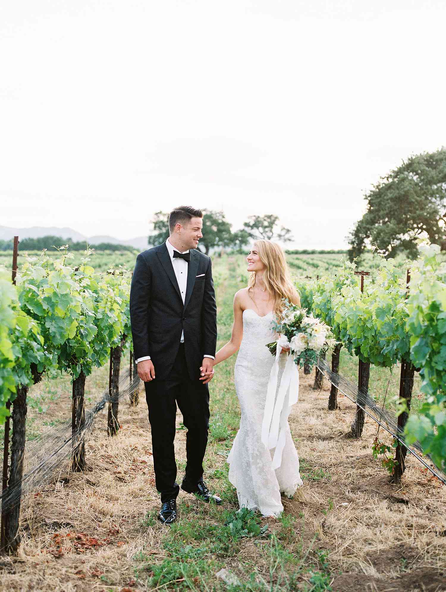 kati erik wedding couple holding hands in vineyard