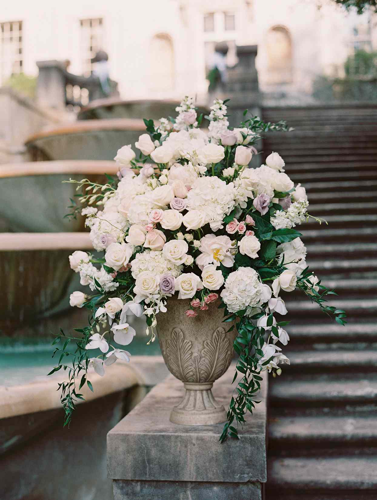 amelia justin wedding ceremony vase of flowers on stone steps