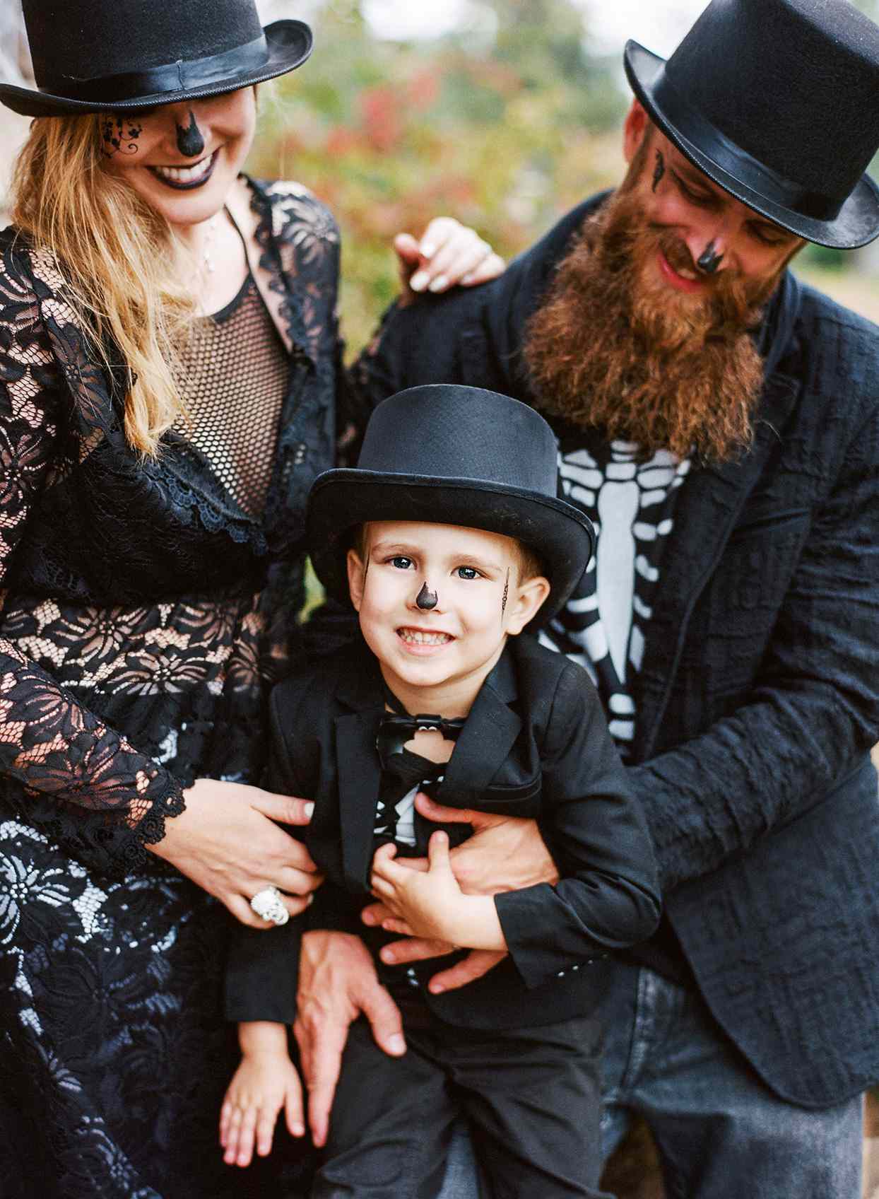 family in halloween masquerade costumes