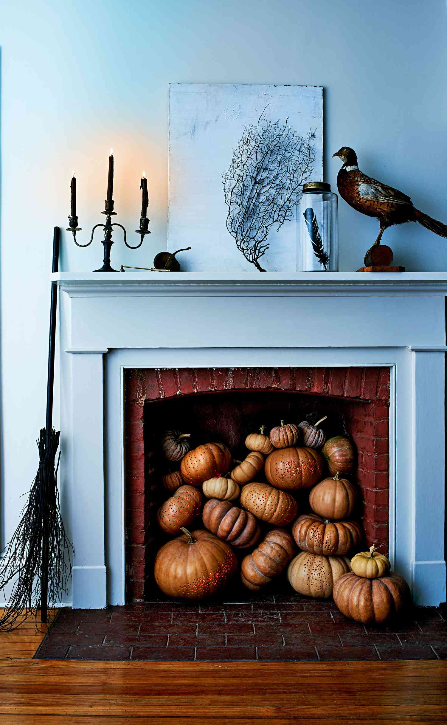 drilled pumpkins in a fireplace