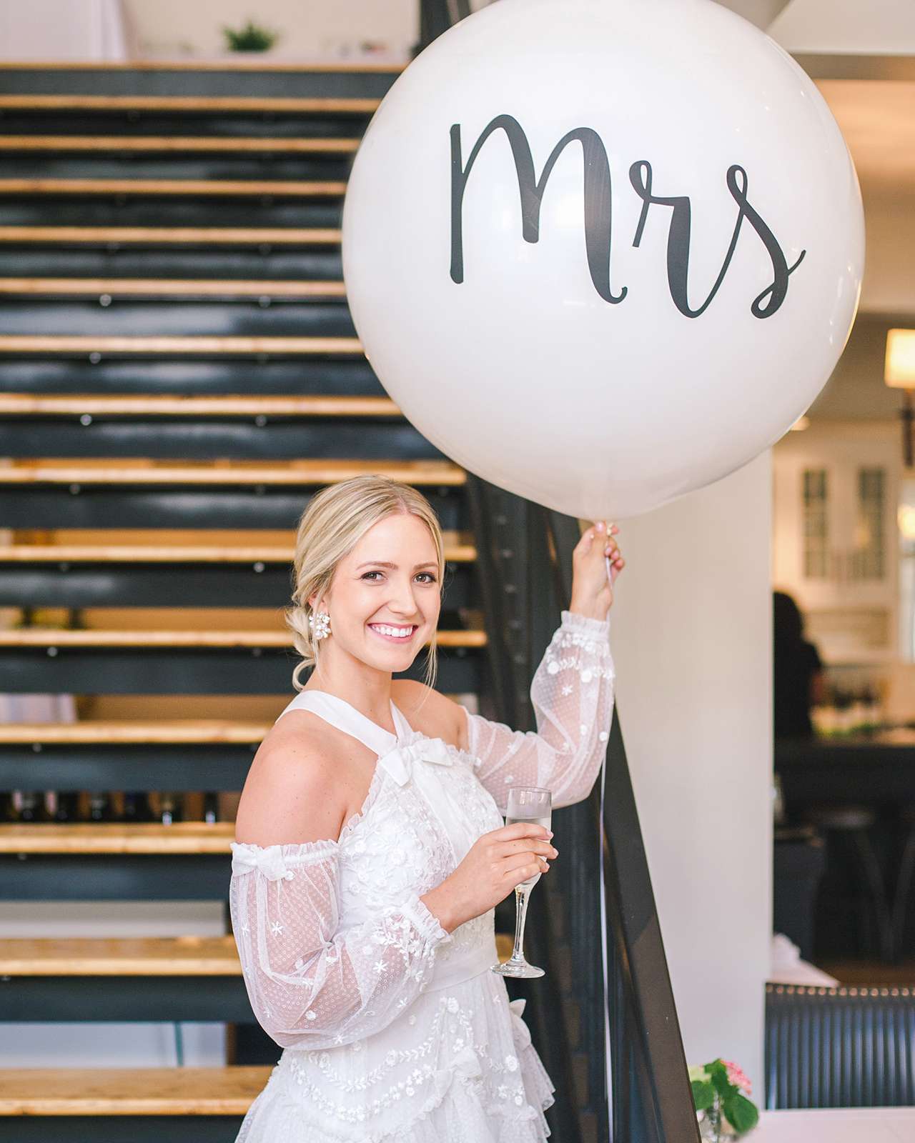 bride holding large mrs balloon