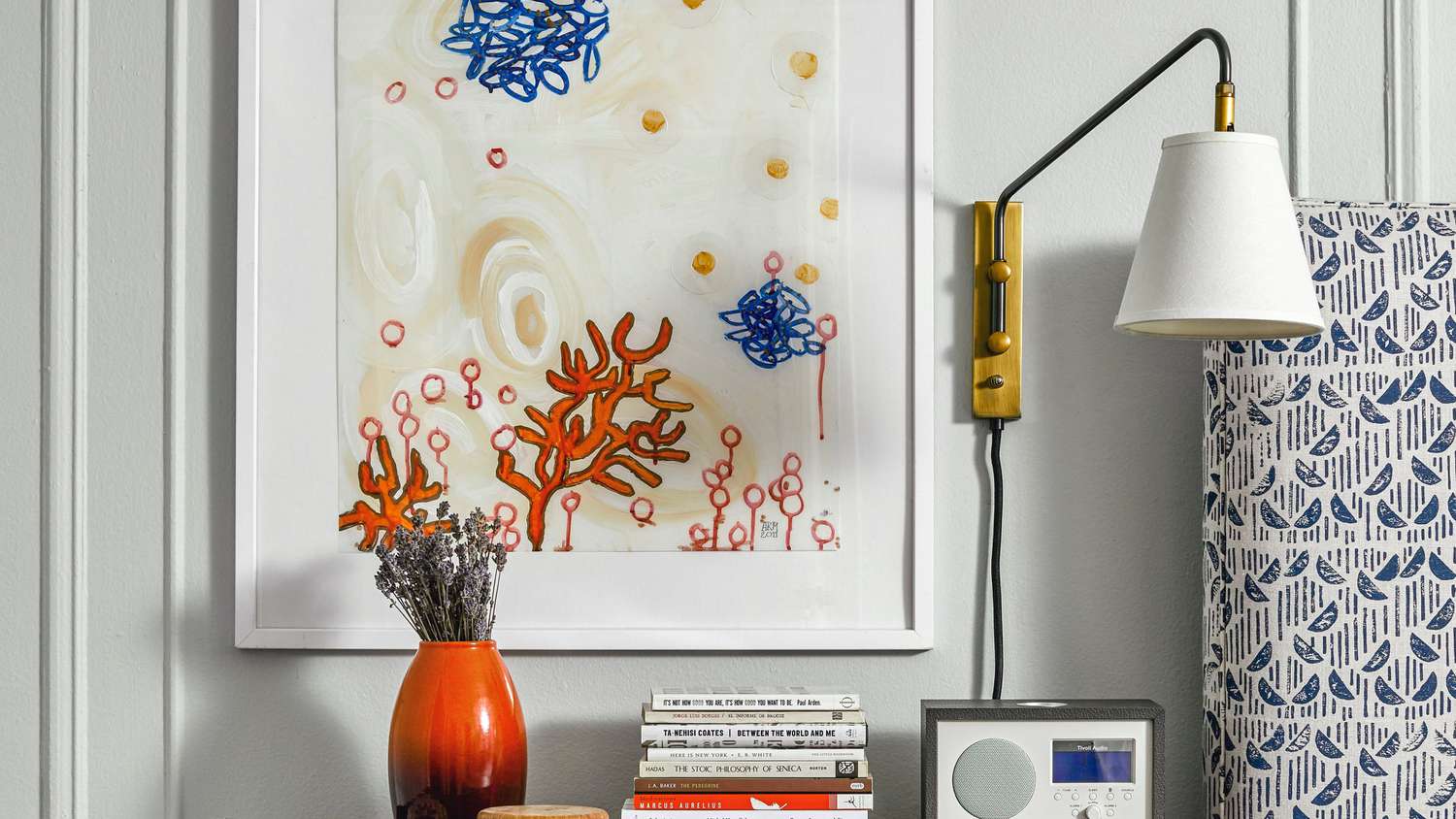 Colorful art hangs over a nightstand