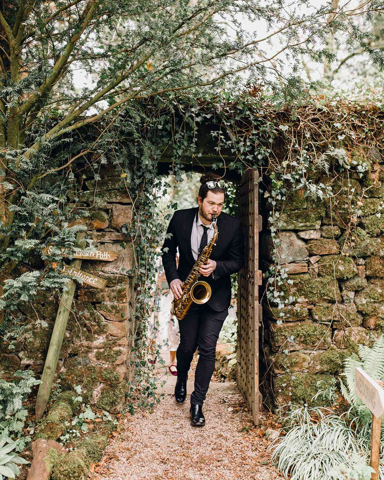 wedding saxophone player garden entrance