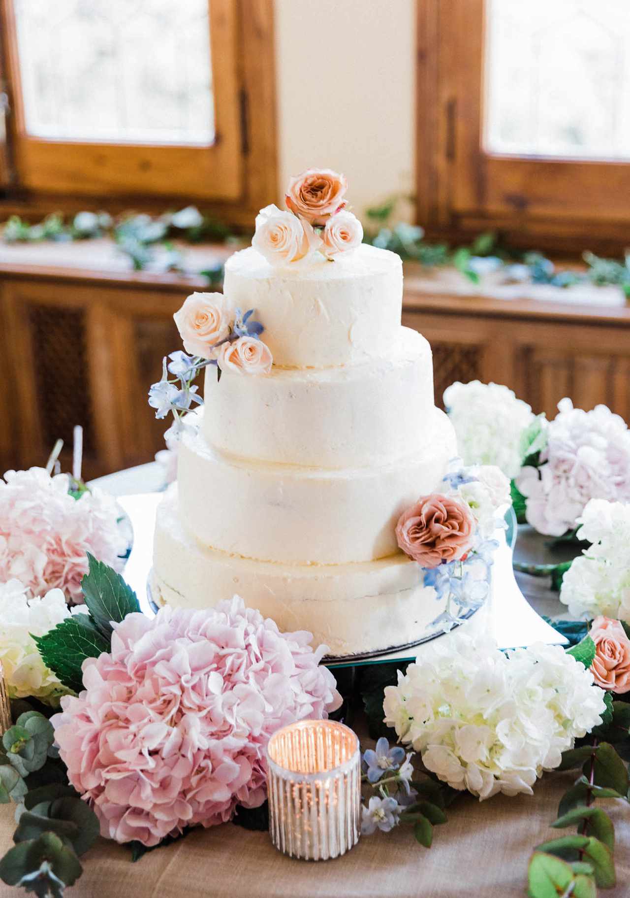four tier wedding cake with floral arrangement
