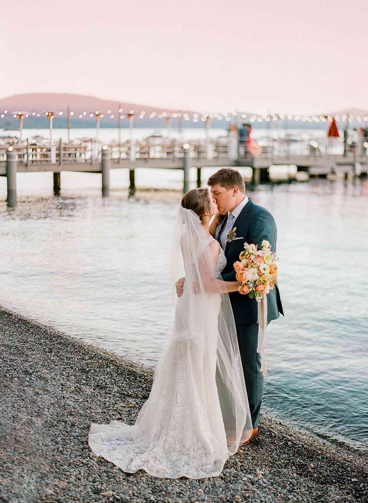 wedding couple kiss lake beach dock view