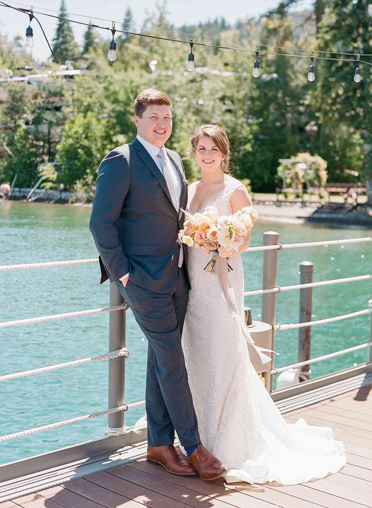 bride groom pose on lake dock forrest background