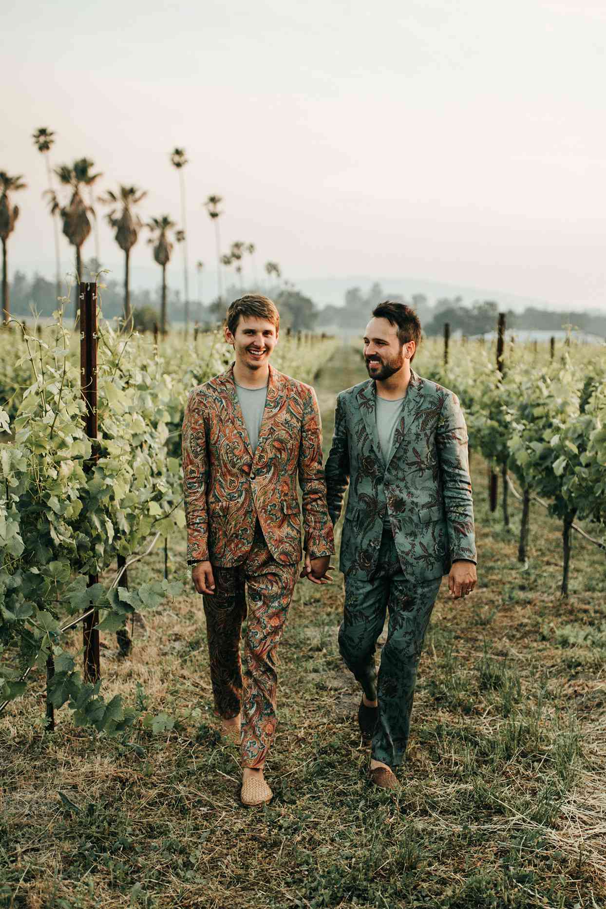 austin alex wedding couple walking through vineyard