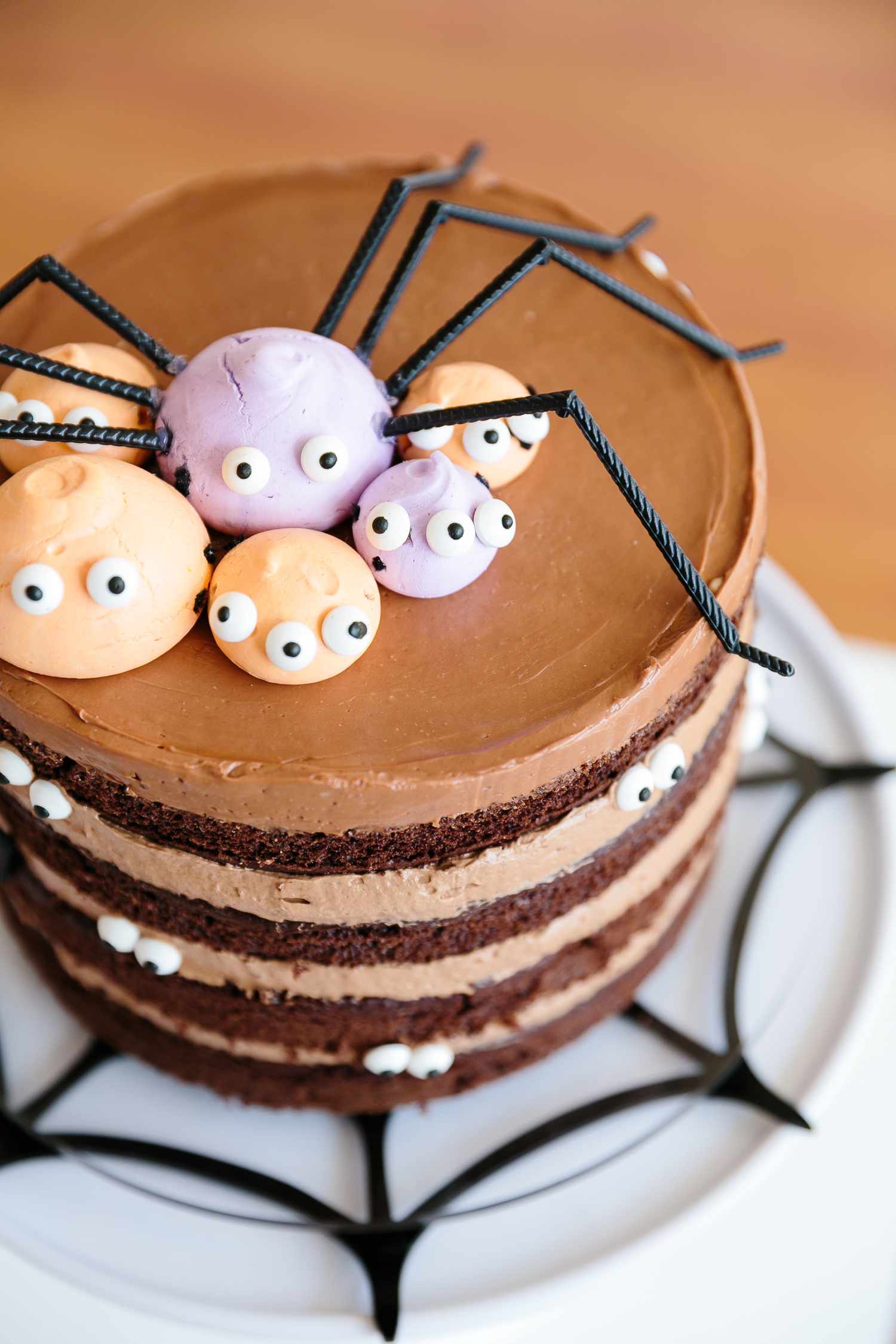 Halloween cake with chocolate frosting and edible spider decorations