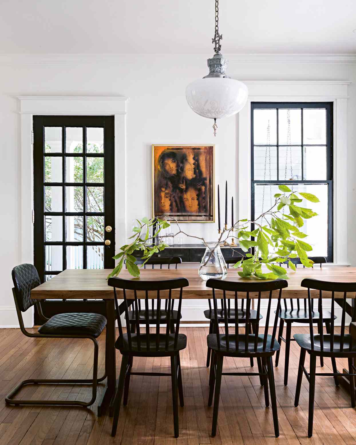 white dining room with vintage oak table and black accents