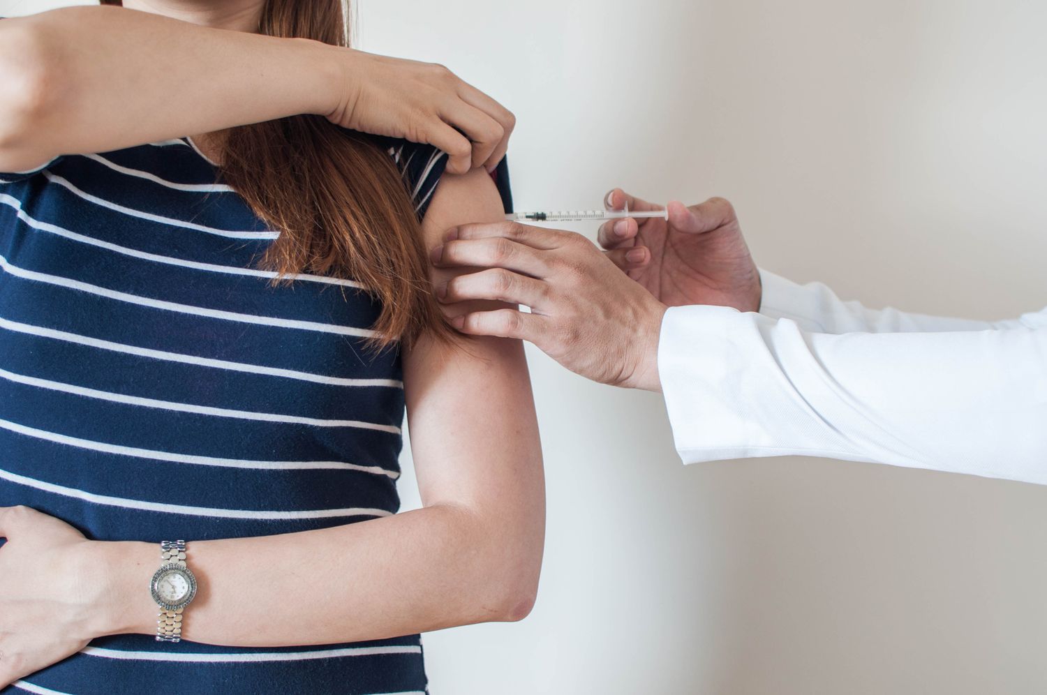 woman getting flu shot vaccine
