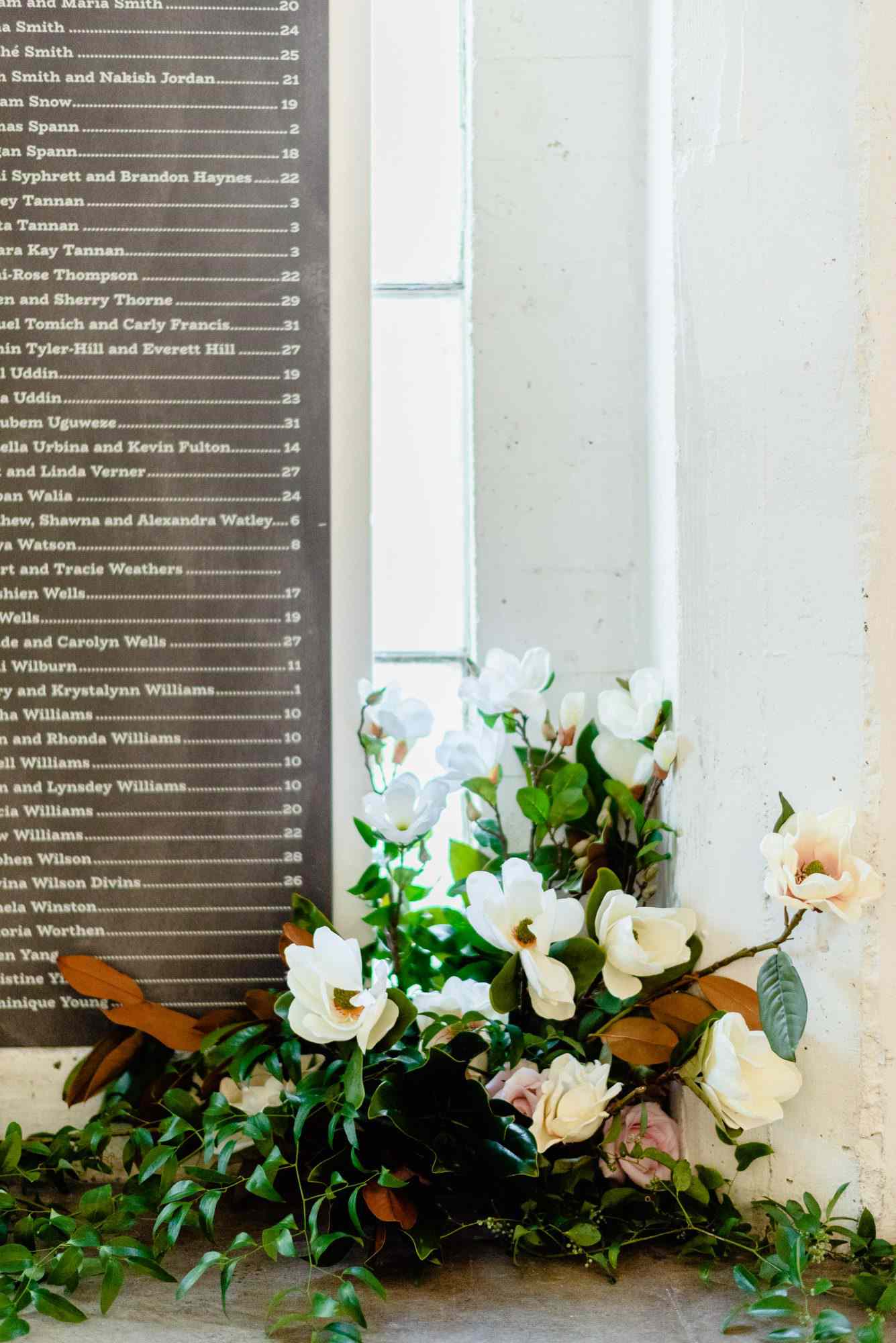 ryan shep wedding seating chart next to flowers