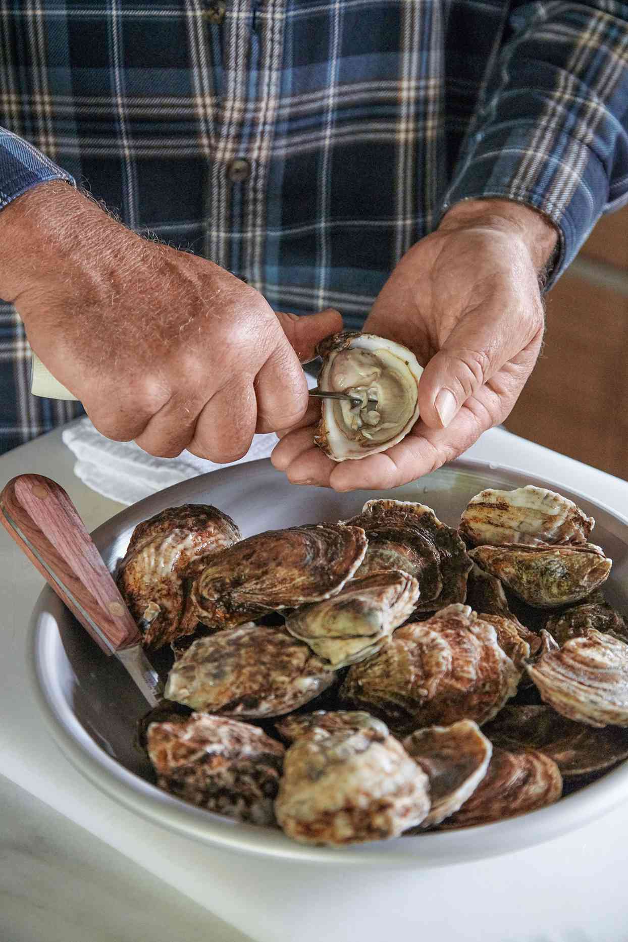 third step of shucking oyster