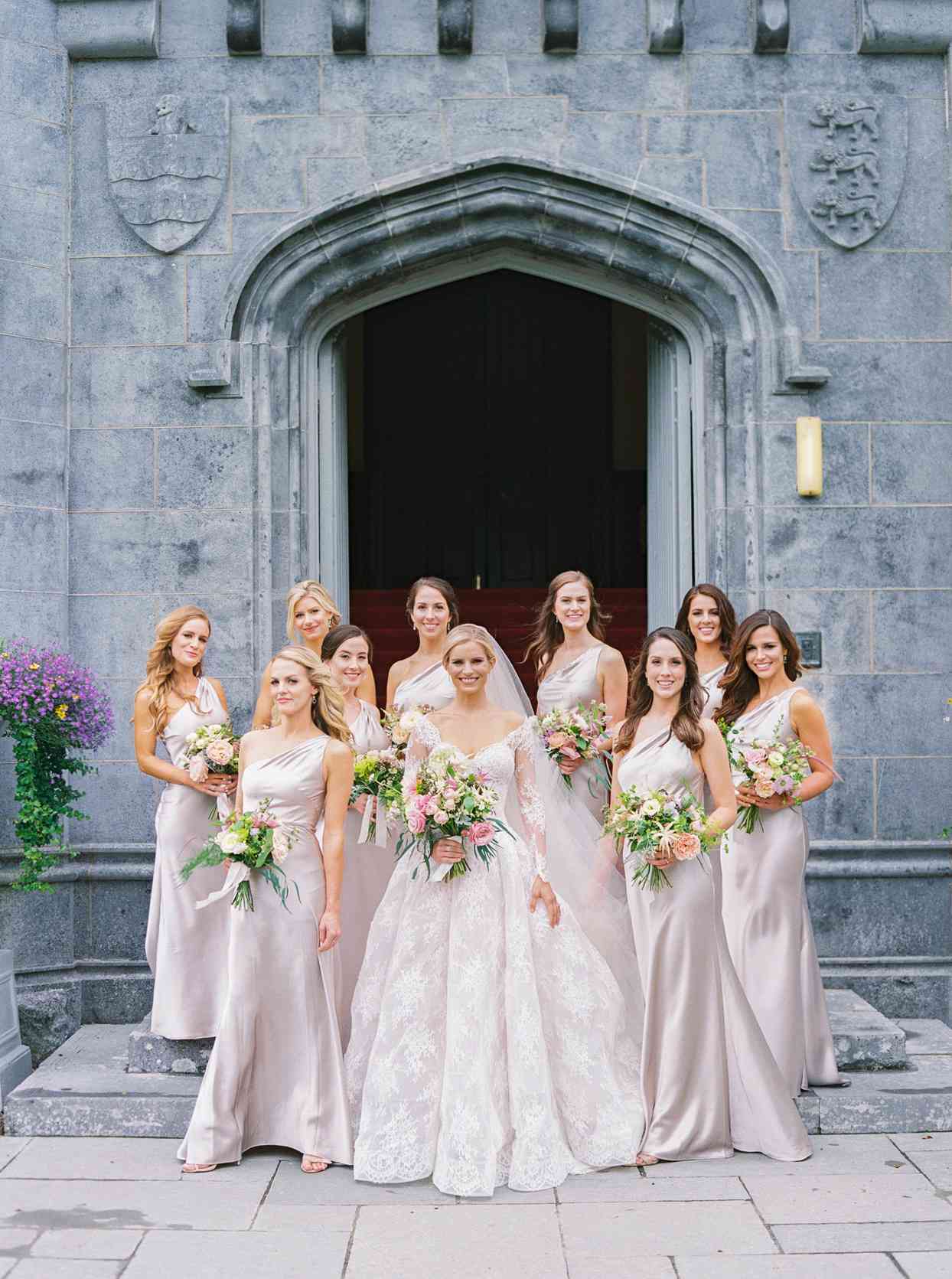 bridesmaids wearing floor length one-shoulder satin Jenny Yoo dresses