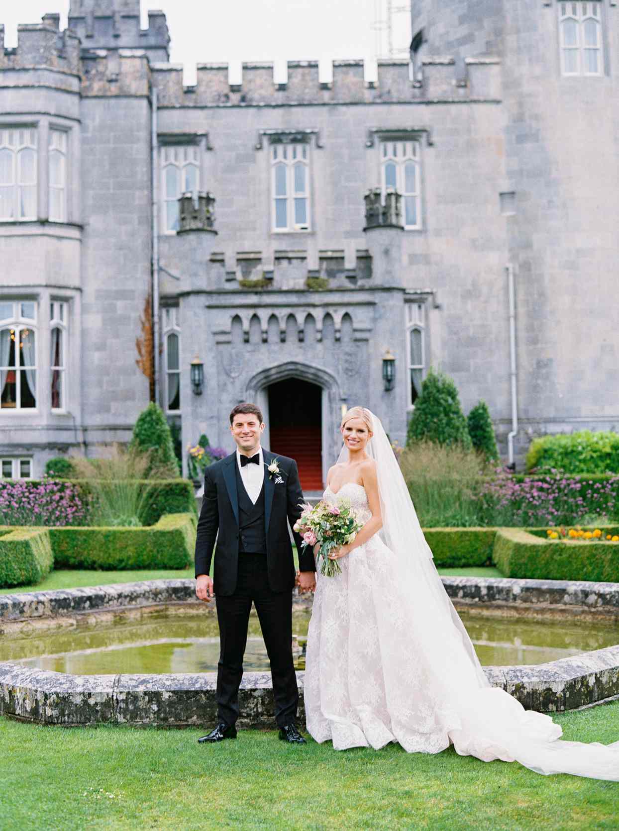 bride and groom standing in front of the Dromoland Castle