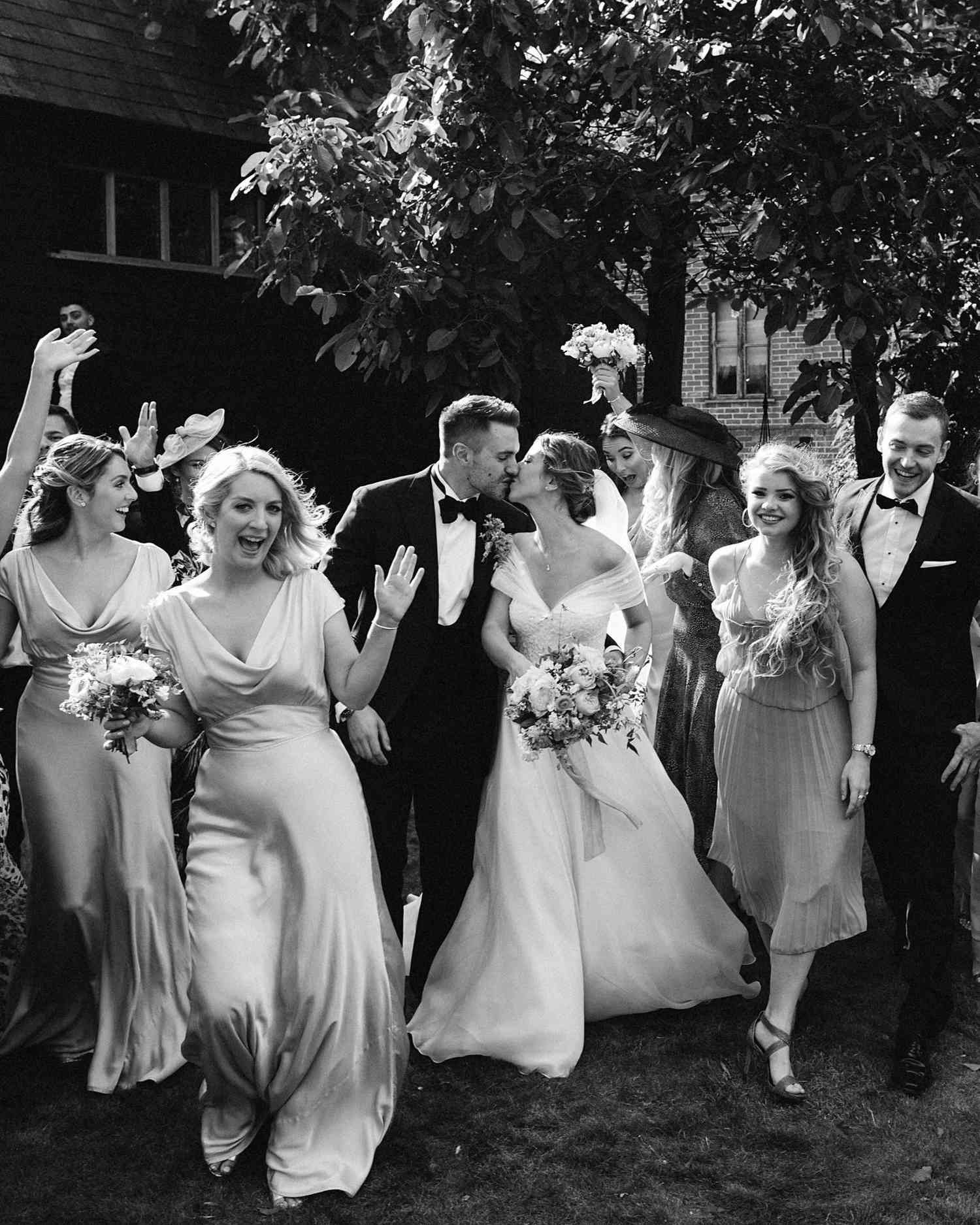 laurie lee wedding couple kiss surrounded by wedding party