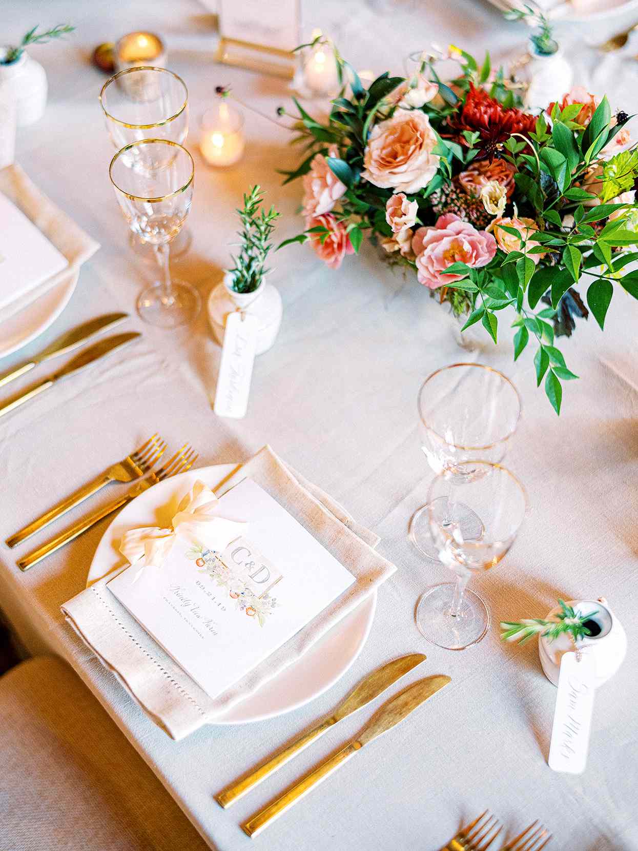 Claire and Dan's wedding reception place setting with gold cutlery