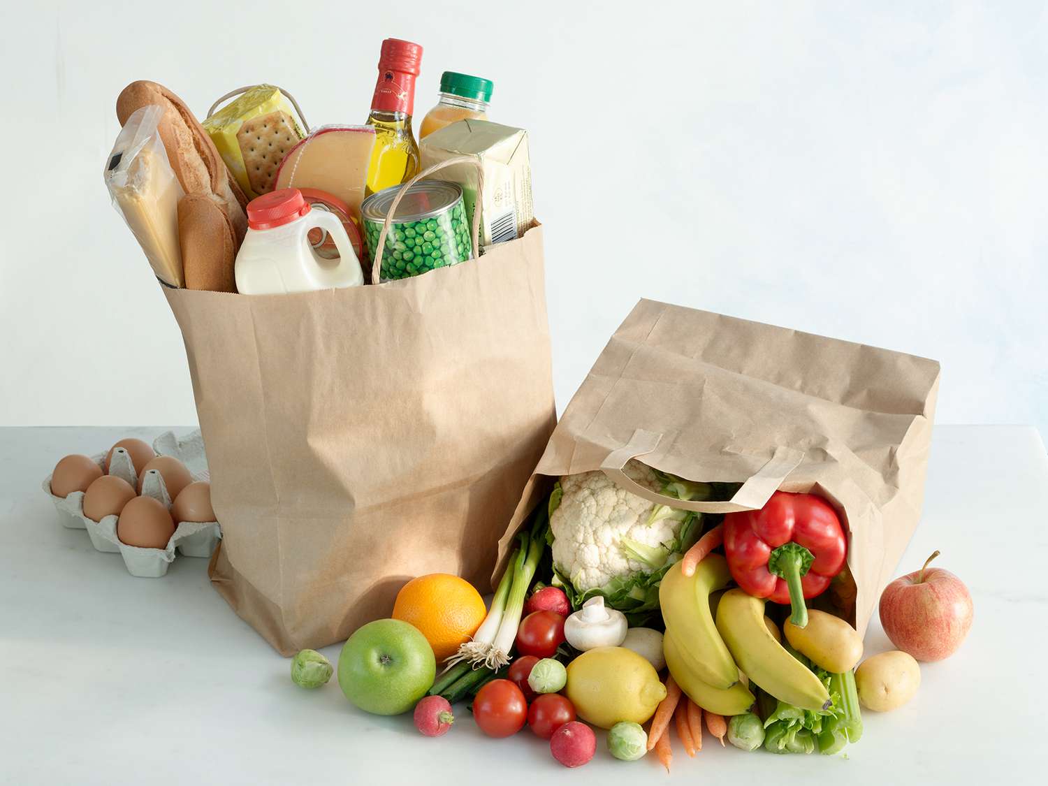 grocery bags with produce and other foods