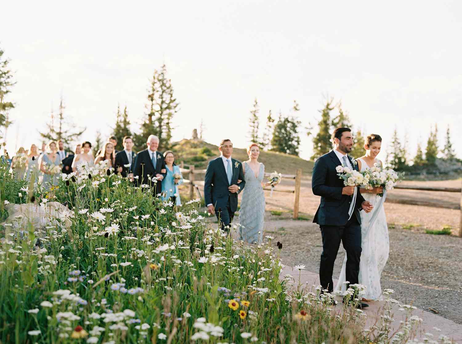 kimmie mike wedding guests walking by flower field