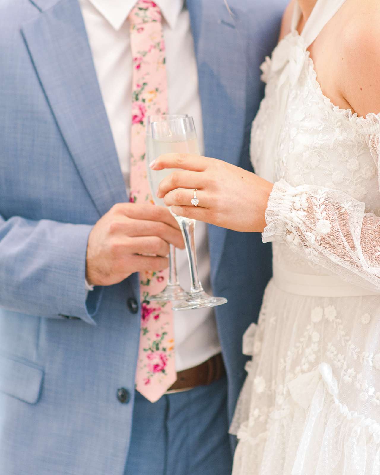 bride groom engagement ring wine glasses