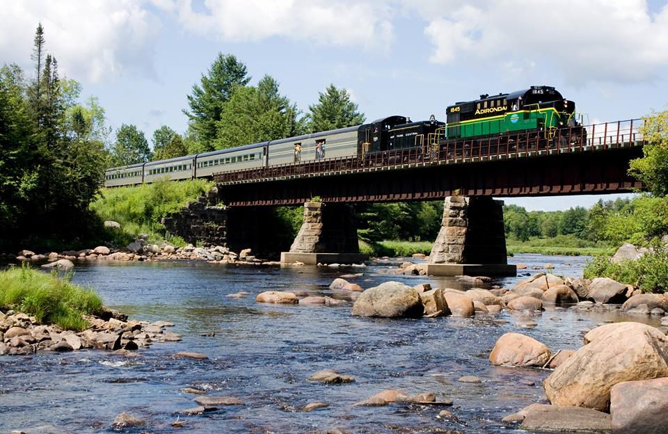 train crossing a bridge on the Adirondack Scenic Railroad