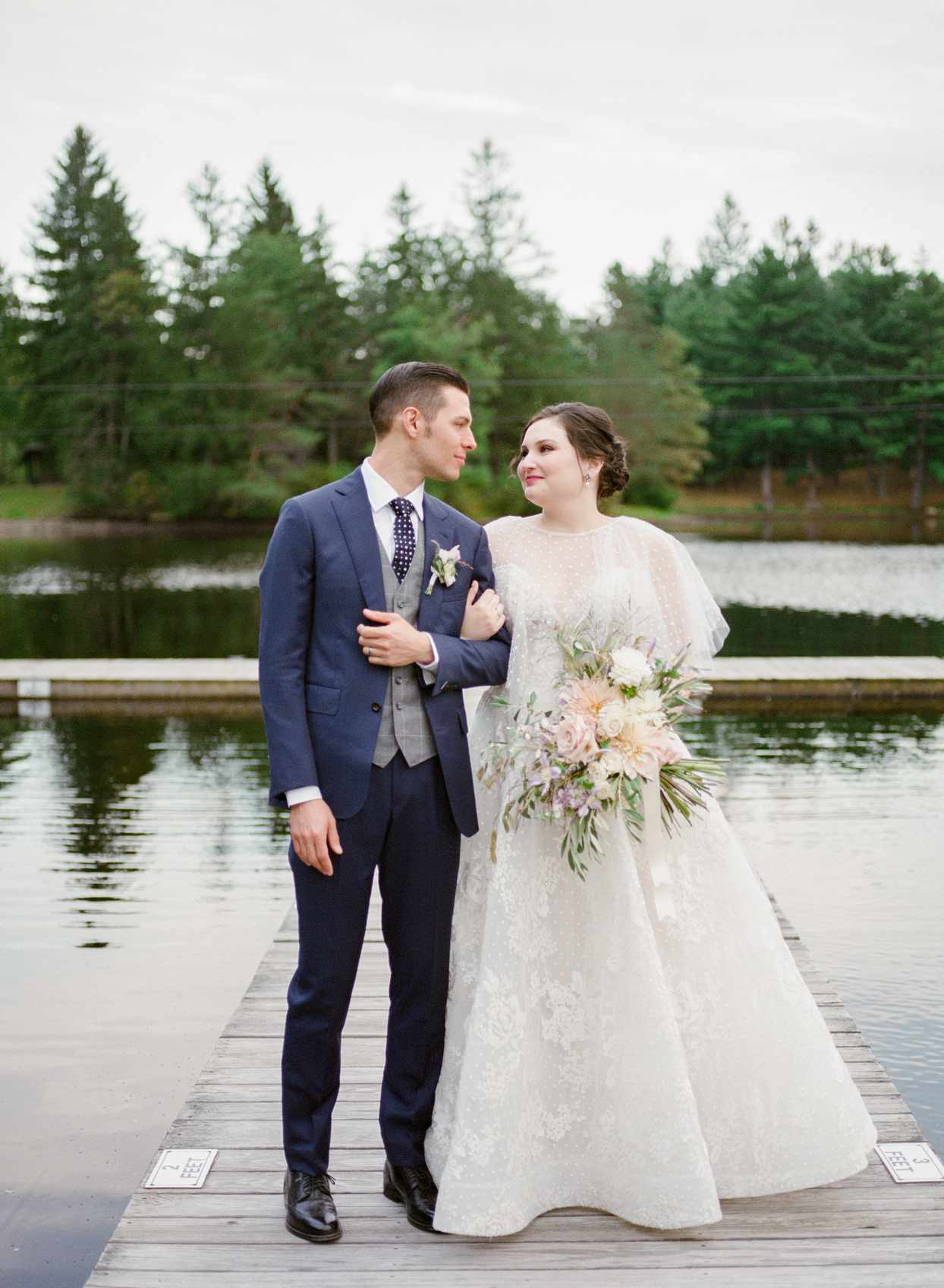 bride and groom standing on dock