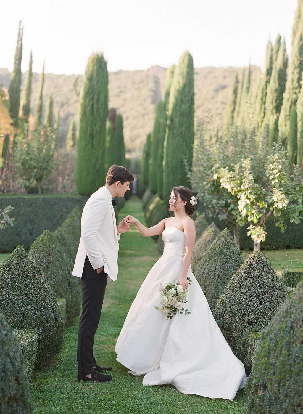 bride and groom posing in italian garden