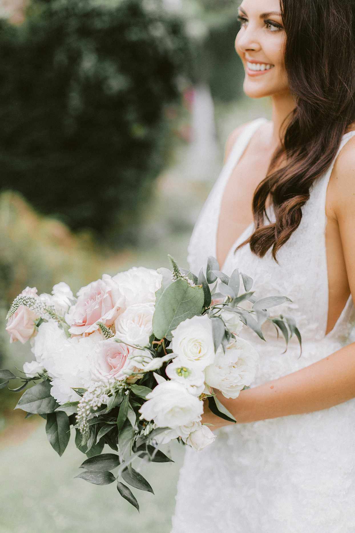 bride holding pastel floral wedding bouquet