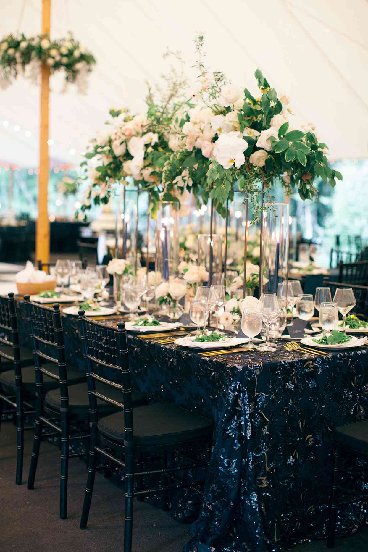 reception tables with shimmering blue tablecloths and tall centerpieces