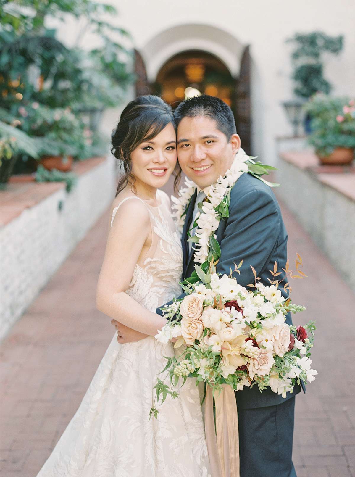 wedding couple hugging for portrait in courtyard