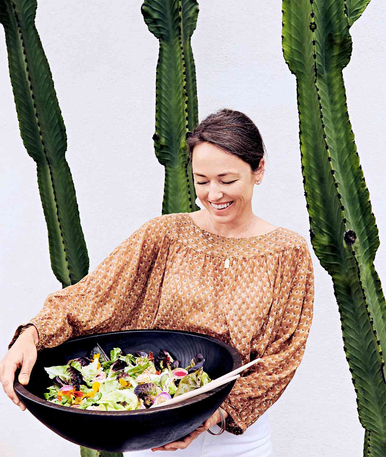 jora vess holding green salad with pickled-shallot vinaigrette