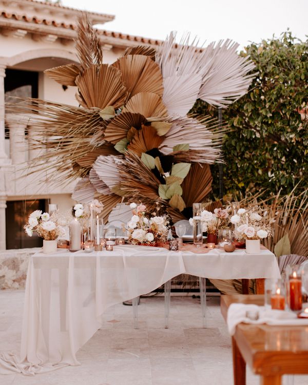 bohemian head table with flowers and candles