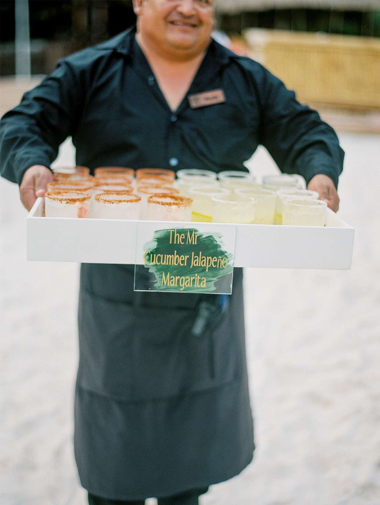 server holding tray of wedding margaritas