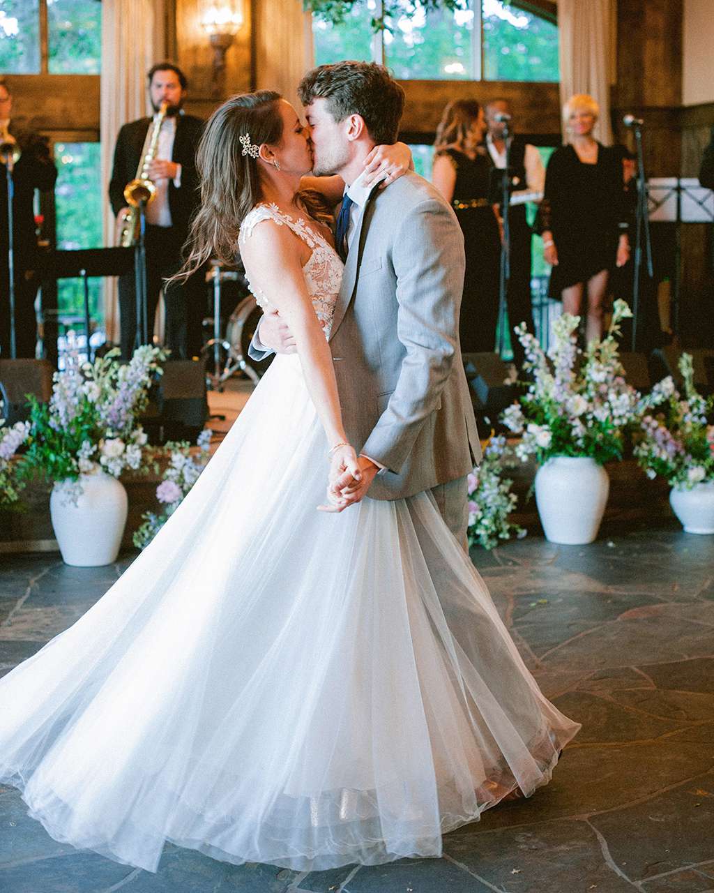 groom bride wedding dance kiss indoors