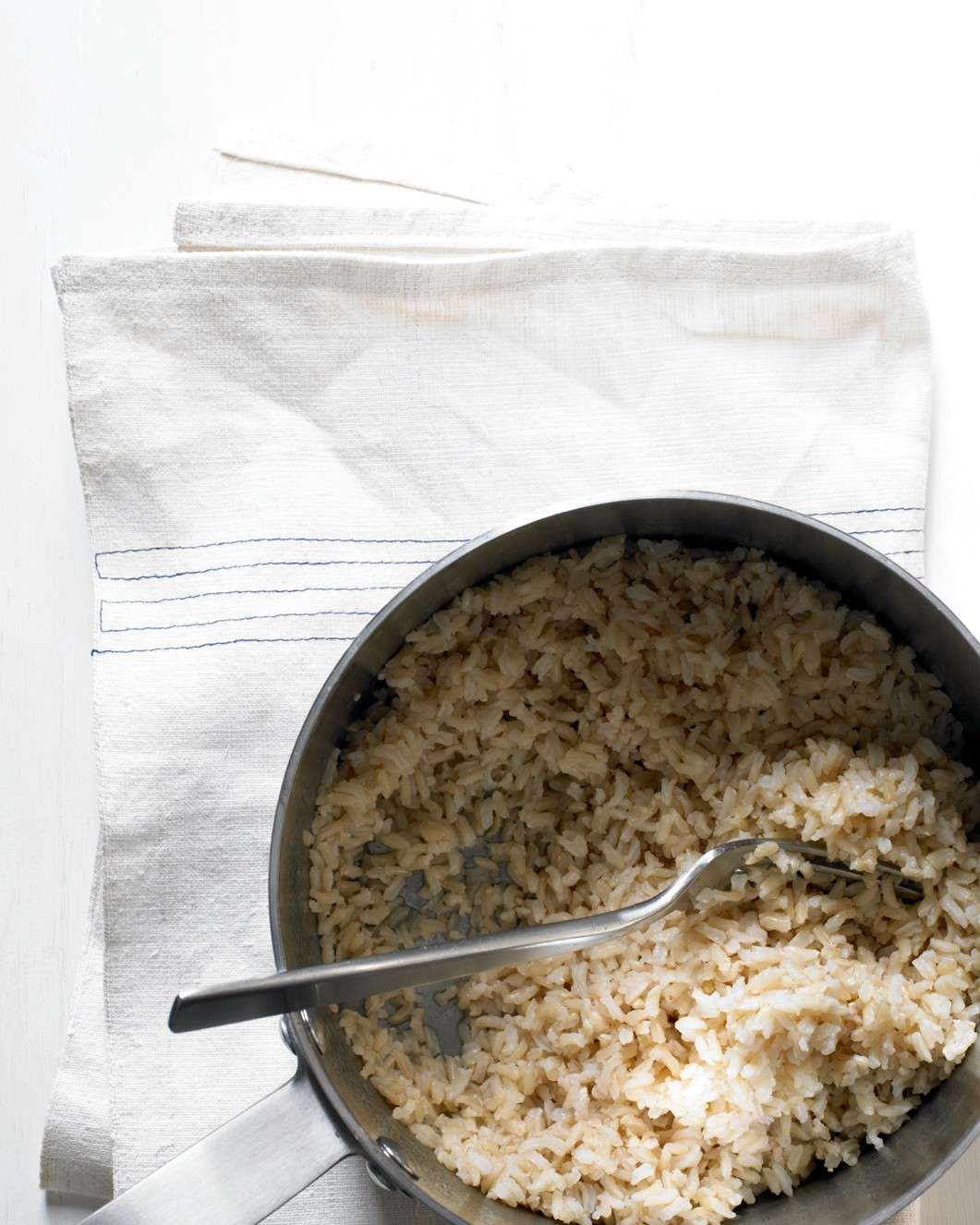 brown rice in pot with fork