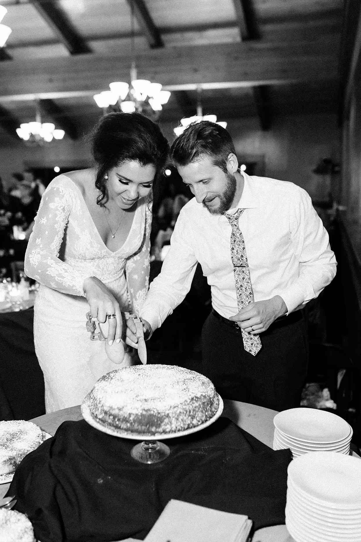 bride and groom cutting wedding cake at reception