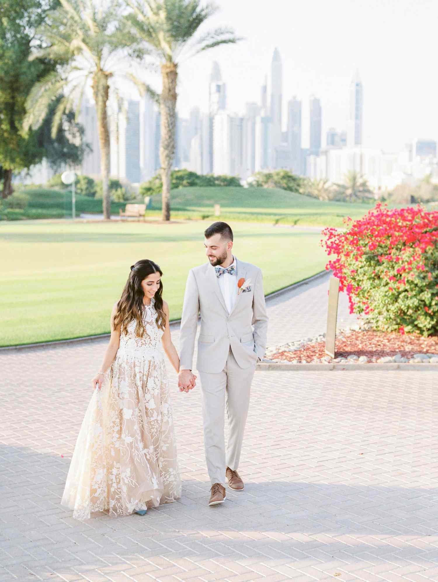 wedding couple hand in hand outdoor Dubai