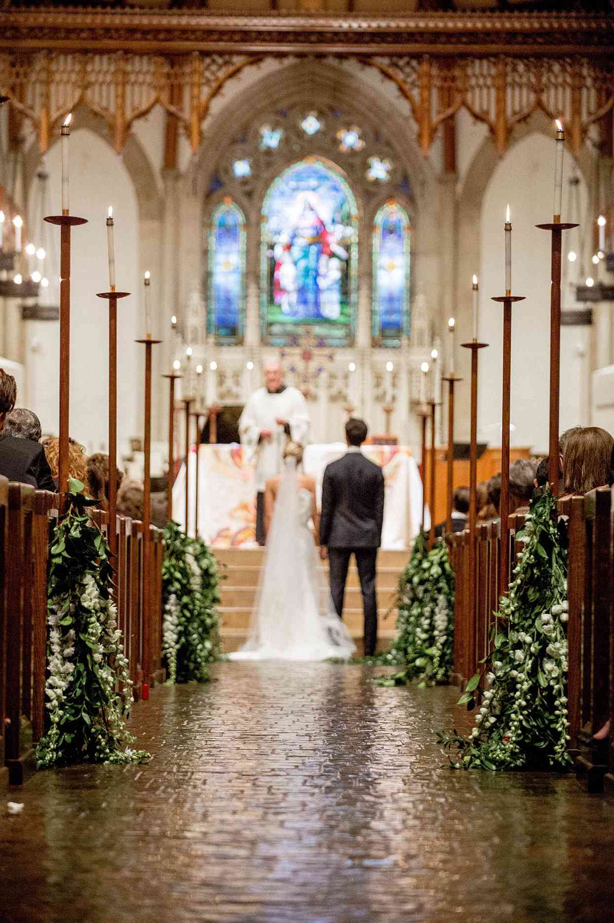 couple standing at altar inside traditional church