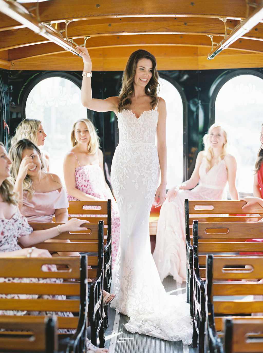 bride and bridesmaids riding wedding trolley