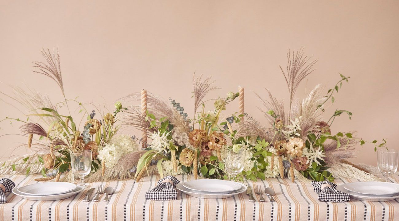 tablescape with patterned linen and floral centerpiece