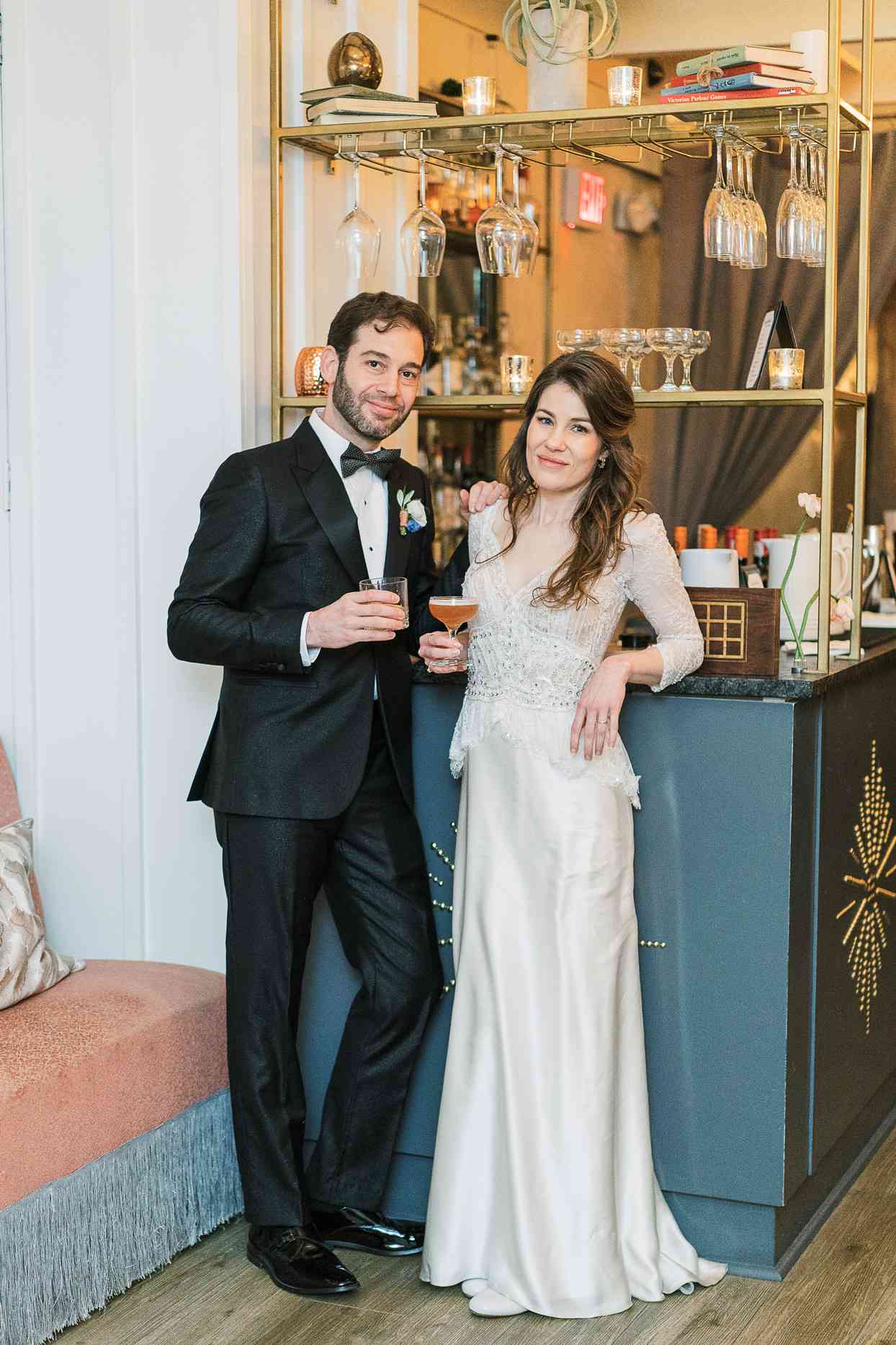 bride and groom holding cocktails during reception