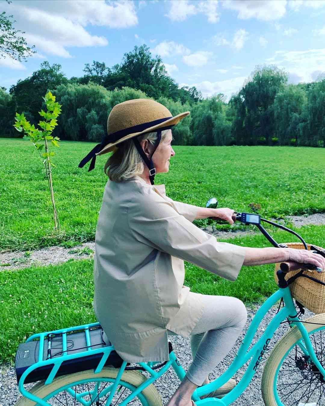 martha stewart bike riding with straw hat helmet