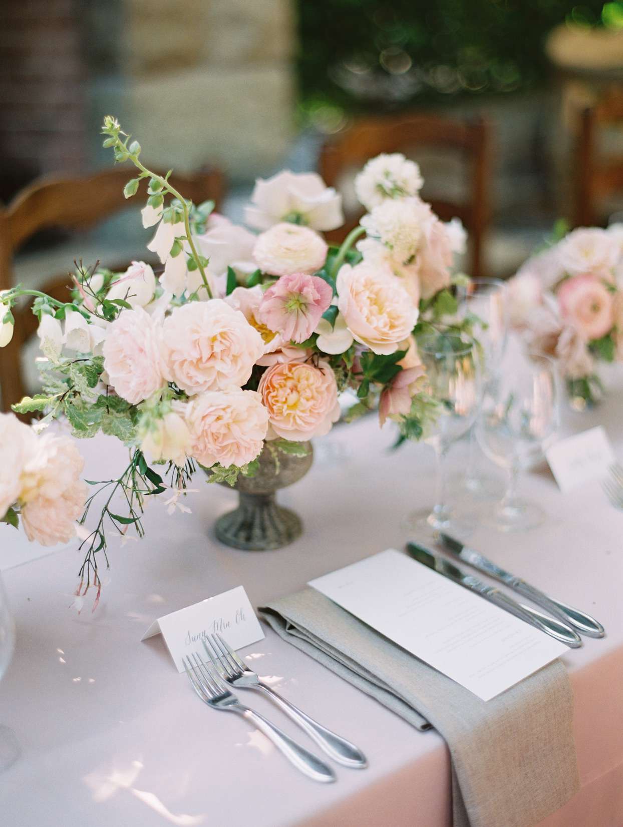 blush floral wedding reception centerpiece at elegant place setting