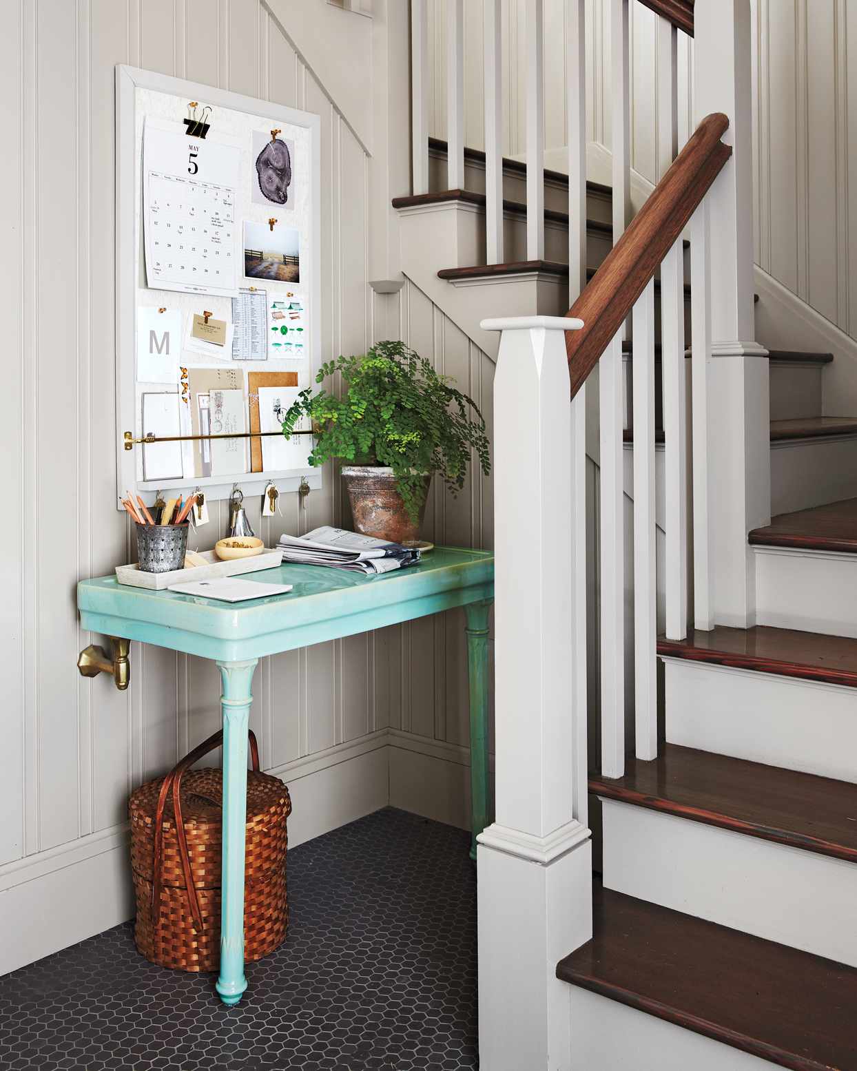 small teal desk in nook by stairway
