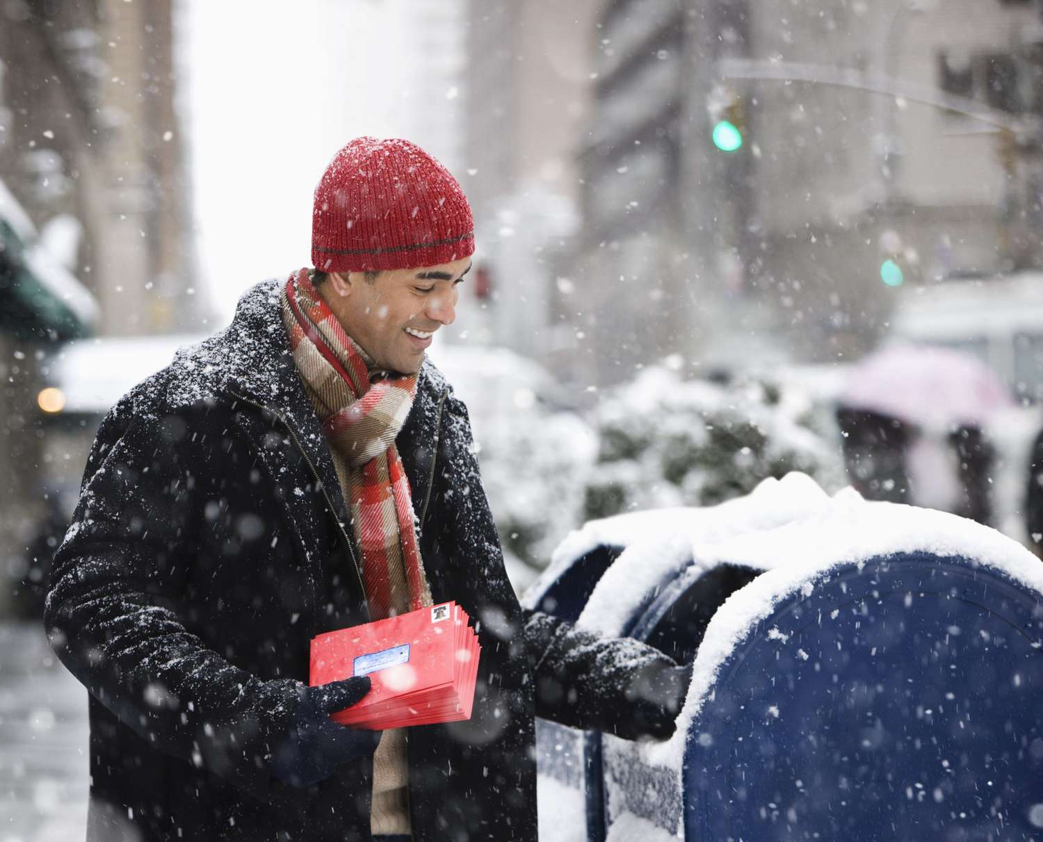 Man mailing Christmas cards in city