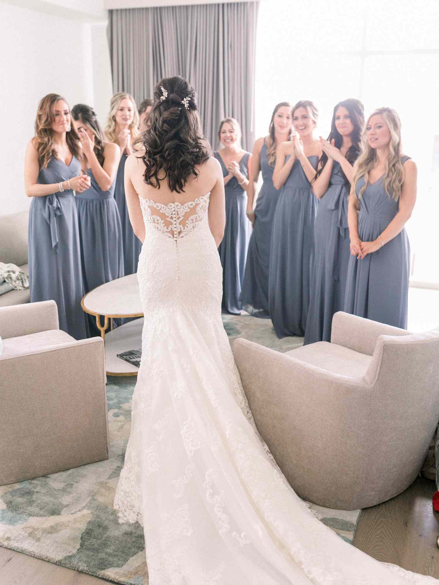 bride's indoor first look with bridesmaids
