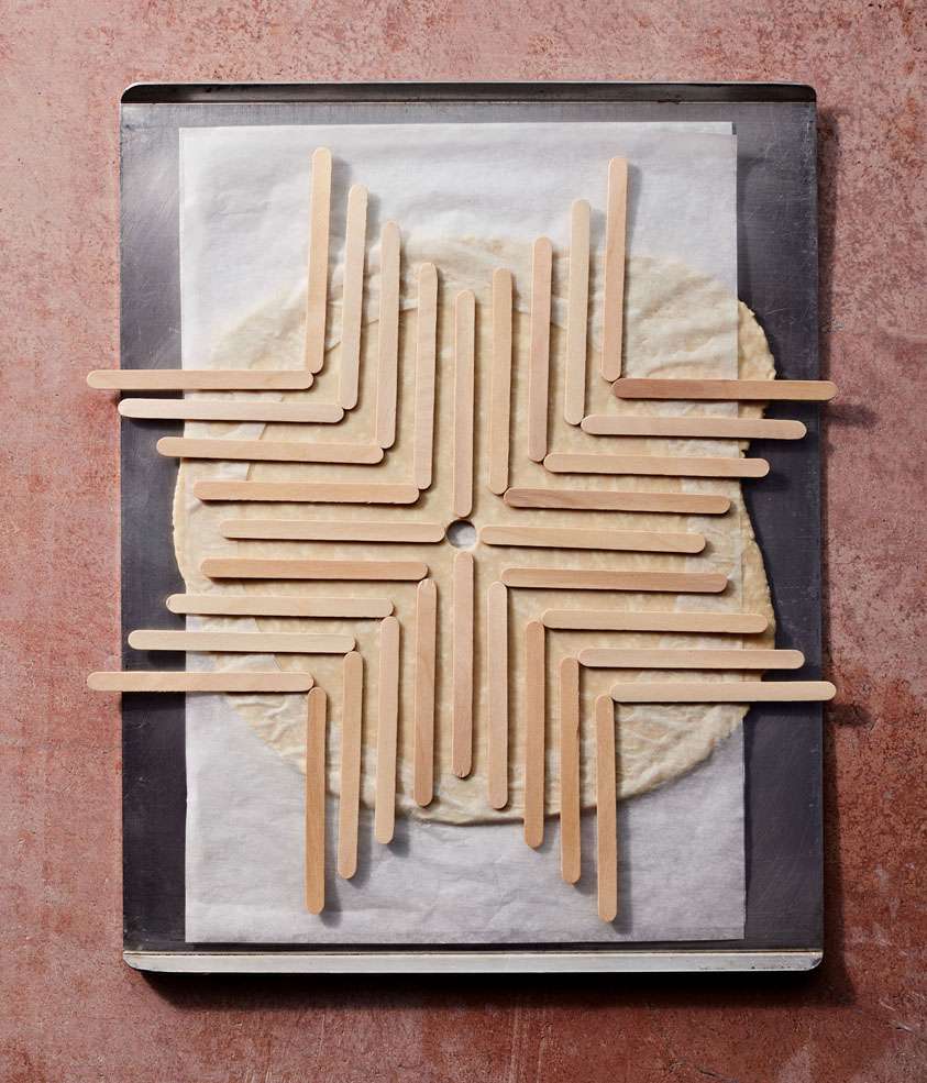 popsicle sticks creating a pattern on pie crust