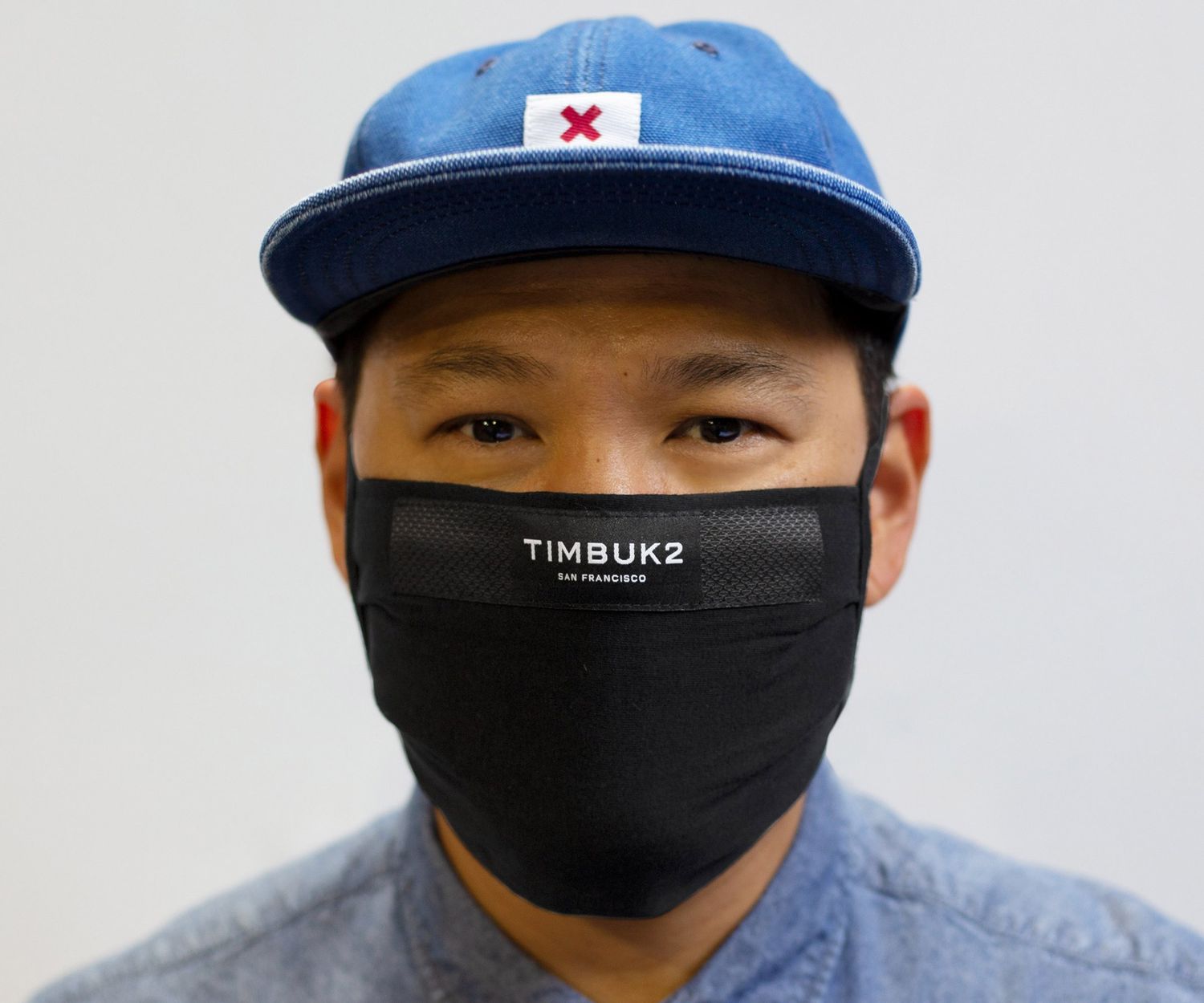 man wearing black TIMBUK2 Reusable Face Mask
