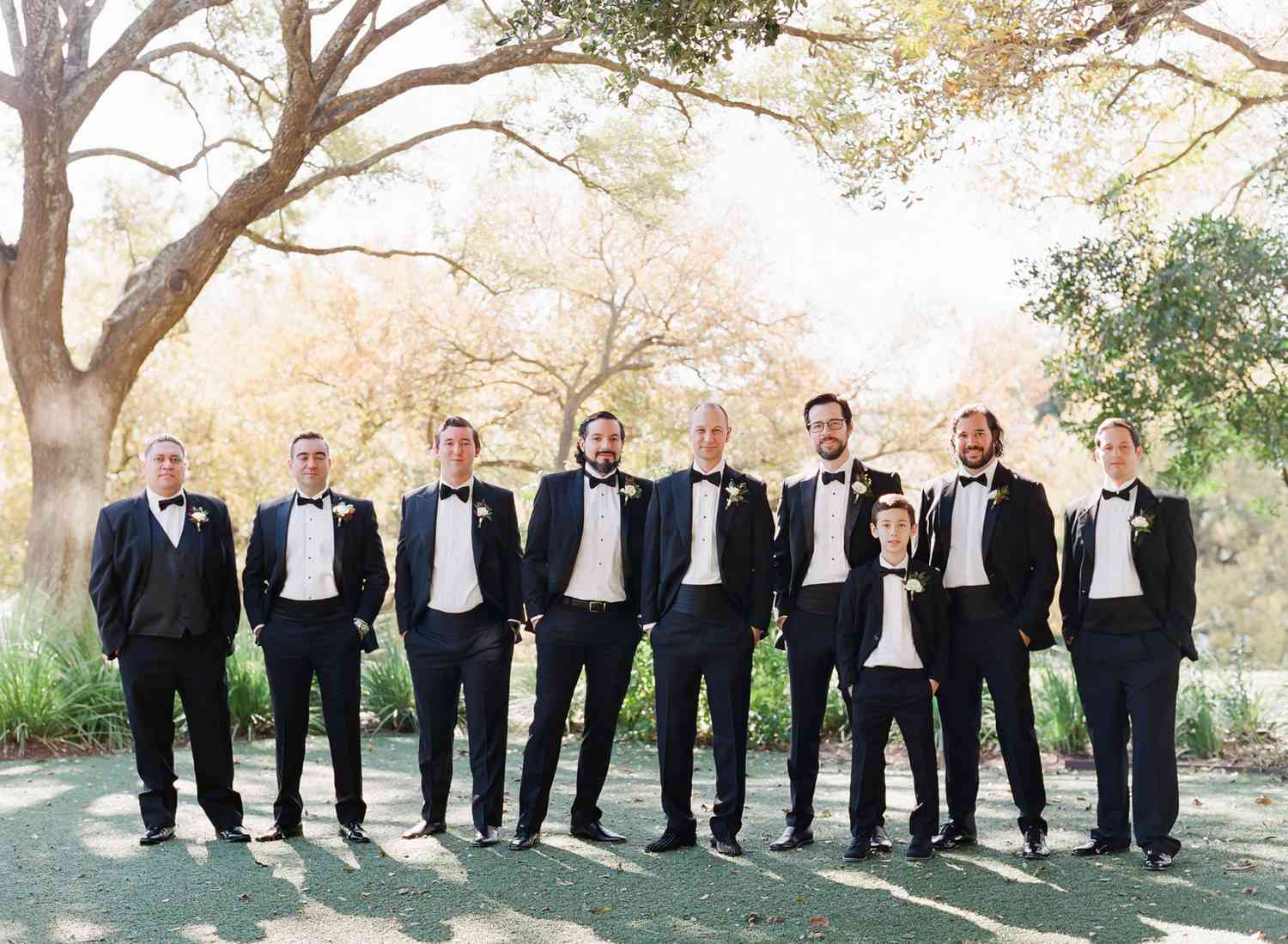 wedding groomsmen in black suits and bowties